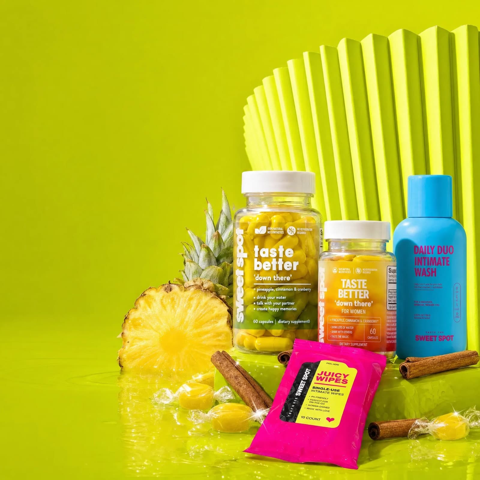 Taste The Sweet Spot lineup with pineapple on a green table