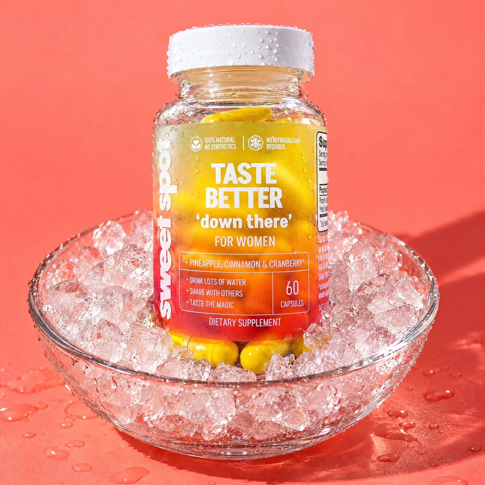 A Taste Better down there For Women bottle, covered in water drops, sits in a glass bowl of ice on a wet coral surface.